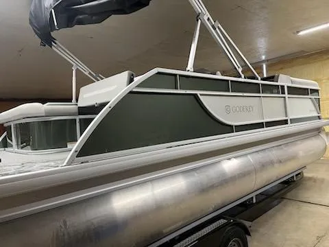 Slide: The Image of 2025 Godfrey 2286SFLX pontoon boat in indoor storage, side view. - 2