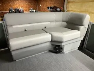 Slide: The Image of 2025 Godfrey 2286SFLX boat seating with gray upholstery and integrated speaker. - 20