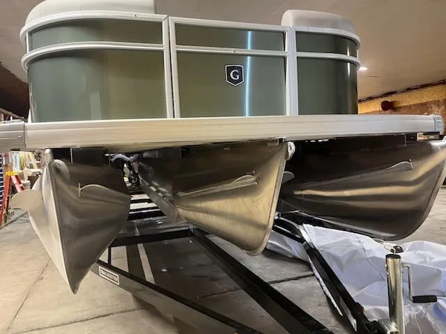 Slide: The Image of 2025 Godfrey 2286SFLX pontoon boat on trailer in garage setting. - 3