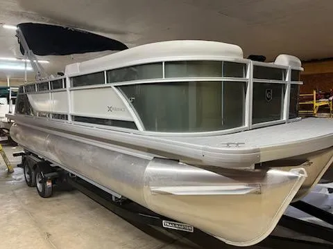 Slide: The Image of 2025 Godfrey 2286SFLX pontoon boat in storage, featuring sleek design and modern amenities. - 4