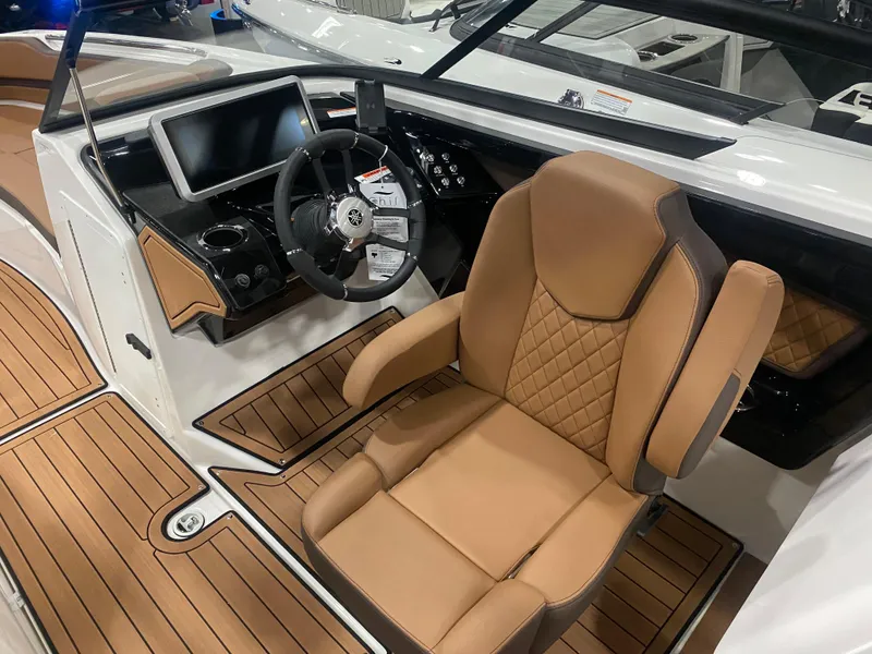 Slide: The Image of 2025 Yamaha Boats 252S cockpit with tan seating and modern dashboard. - 2