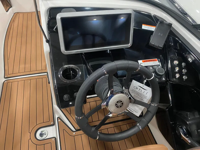 Slide: The Image of 2025 Yamaha Boats 252S dashboard with steering wheel and touchscreen display. - 3