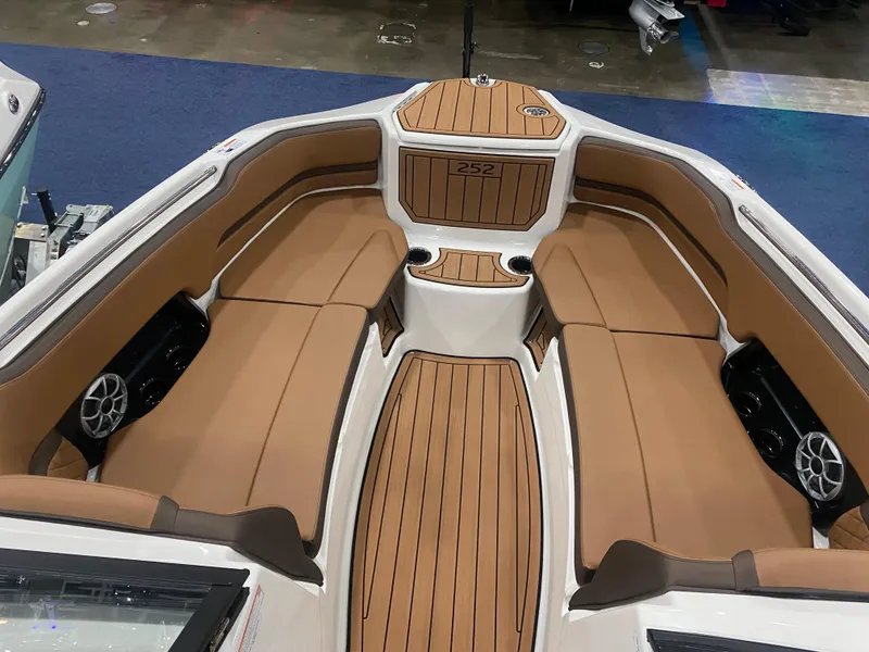 Slide: The Image of 2025 Yamaha Boats 252S interior with tan seating and wood accents. - 5