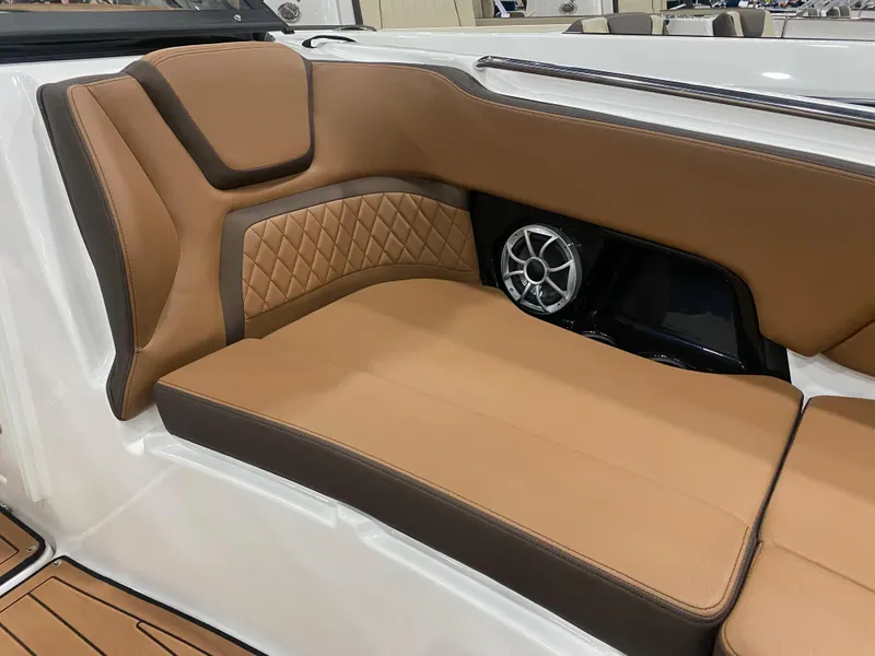 Slide: The Image of Luxurious seating in 2025 Yamaha Boats 252S with tan upholstery and speaker detail. - 6