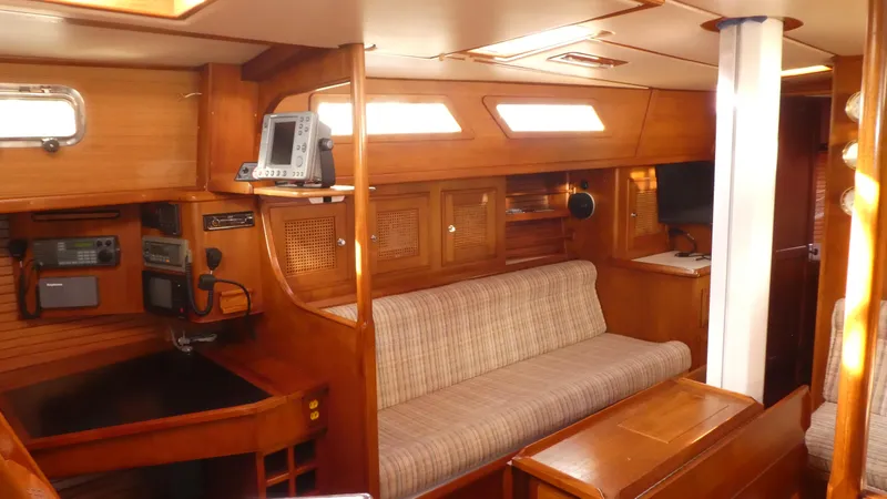 Slide: The Image of Interior of 1990 Celestial 48 Center Cockpit yacht with wooden furnishings and seating area. - 10