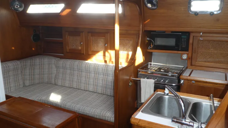 Slide: The Image of Interior of 1990 Celestial 48 Center Cockpit yacht with kitchen and seating area. - 12