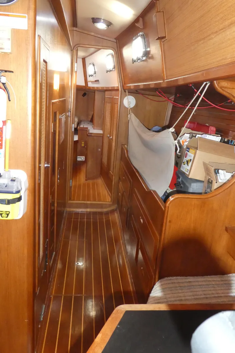 Slide: The Image of Interior of 1990 Celestial 48 Center Cockpit sailboat with wooden finishes and storage space. - 15