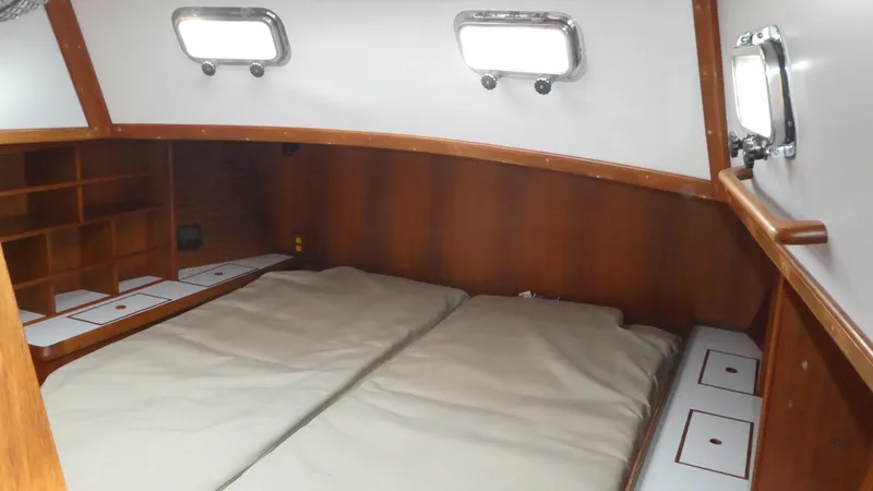 Slide: The Image of Interior cabin of 1990 Celestial 48 Center Cockpit sailboat with wooden finish and bedding. - 16