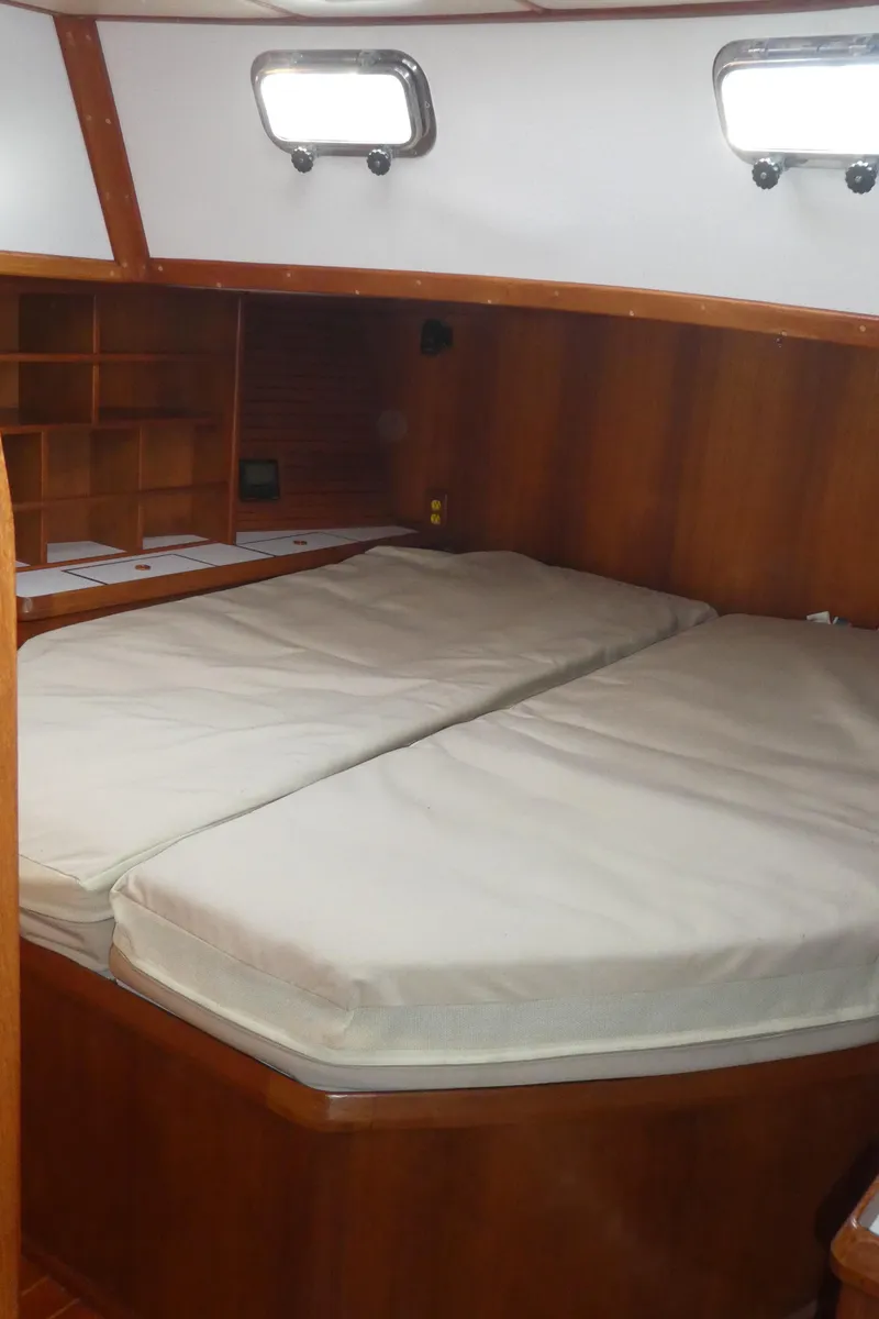 Slide: The Image of Interior cabin of 1990 Celestial 48 Center Cockpit sailboat with wooden finish and bed. - 18