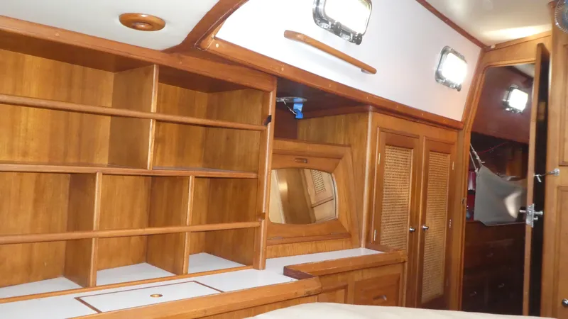 Slide: The Image of Interior of 1990 Celestial 48 Center Cockpit yacht with wooden cabinetry and shelving. - 19