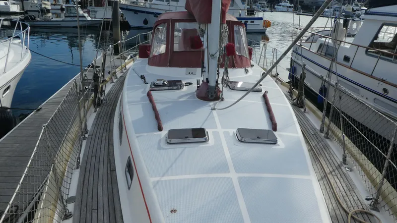 Slide: The Image of 1990 Celestial 48 Center Cockpit sailboat docked in a marina. - 2