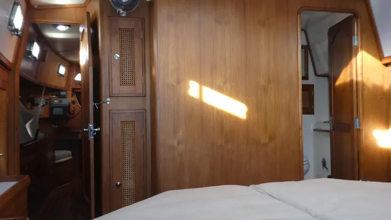 Slide: The Image of Interior of 1990 Celestial 48 Center Cockpit yacht with wooden paneling and cozy cabin. - 20