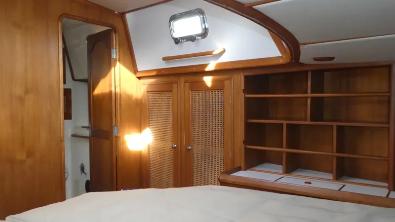 Slide: The Image of Interior of 1990 Celestial 48 Center Cockpit yacht with wooden cabinetry and shelving. - 21