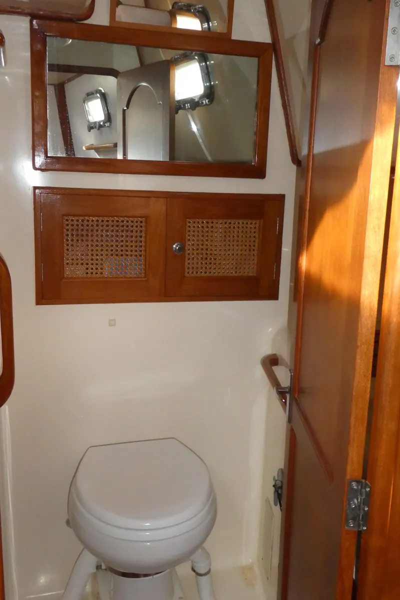 Slide: The Image of Bathroom interior of 1990 Celestial 48 Center Cockpit yacht with wooden cabinetry. - 23