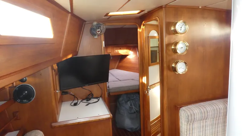 Slide: The Image of Interior of 1990 Celestial 48 Center Cockpit yacht with wood paneling and cozy cabin. - 24