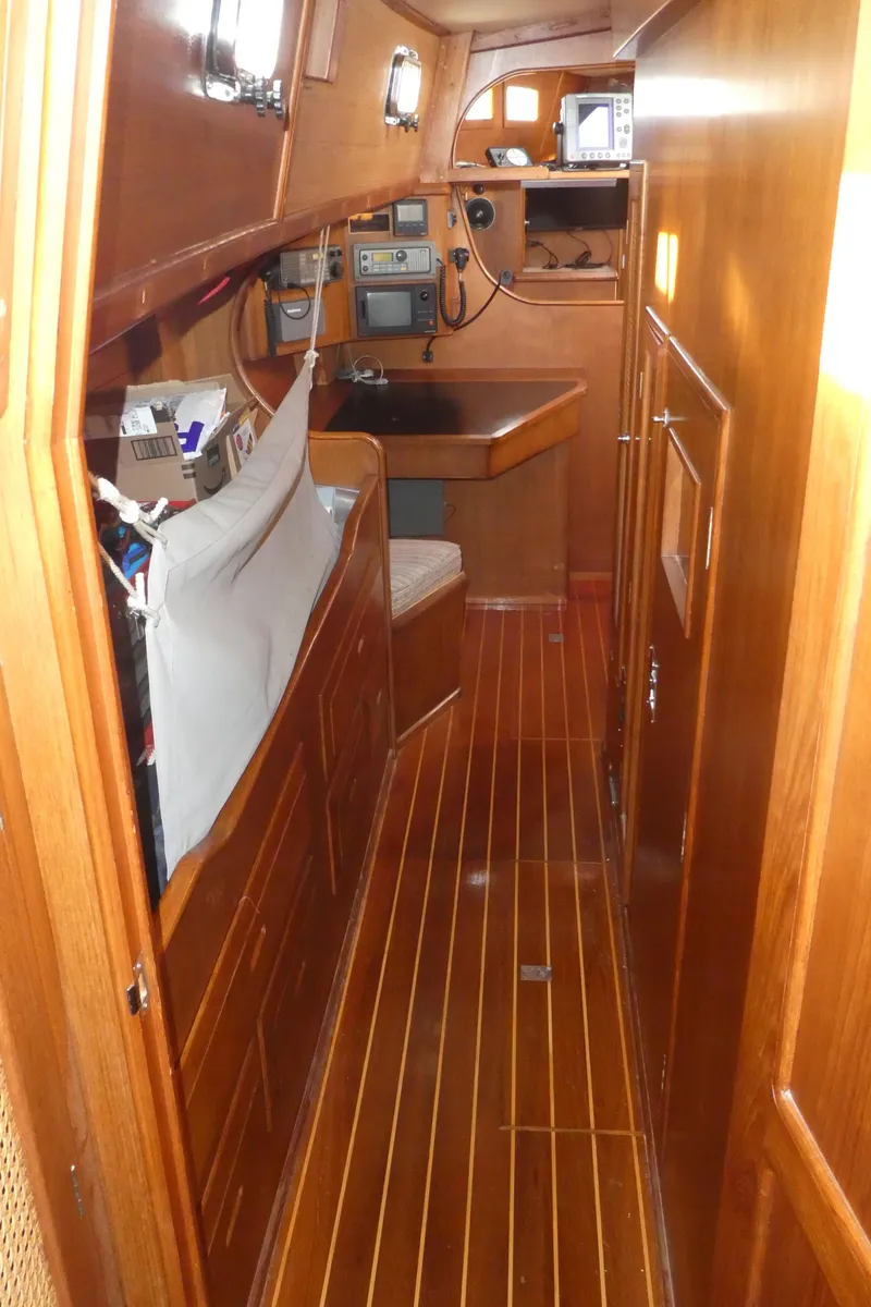 Slide: The Image of Interior of 1990 Celestial 48 Center Cockpit yacht with wooden finish and navigation equipment. - 26