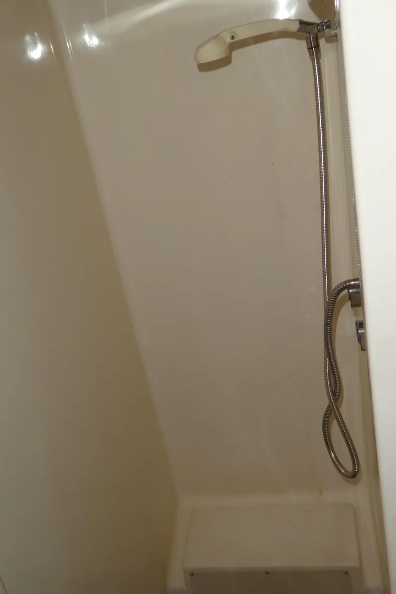 Slide: The Image of Shower area in 1990 Celestial 48 Center Cockpit yacht, featuring a handheld showerhead. - 31