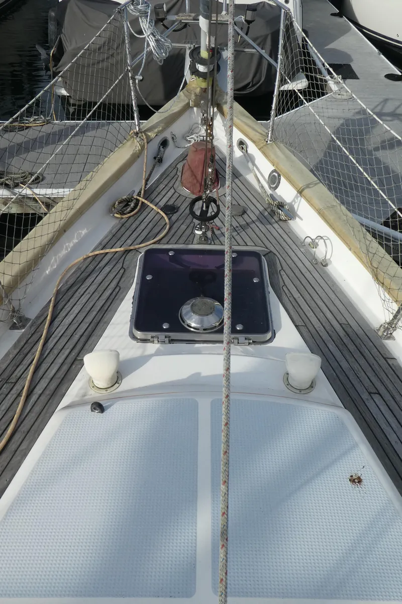 Slide: The Image of Deck view of a 1990 Celestial 48 Center Cockpit sailboat, showcasing rigging and hatch. - 4