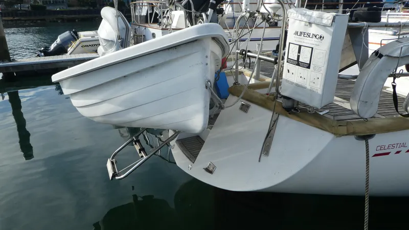 Slide: The Image of Sailboat stern with dinghy, Celestial 48 Center Cockpit, 1990 model, docked in marina. - 40