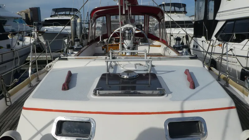 Slide: The Image of 1990 Celestial 48 Center Cockpit yacht docked among other boats in a marina. - 5