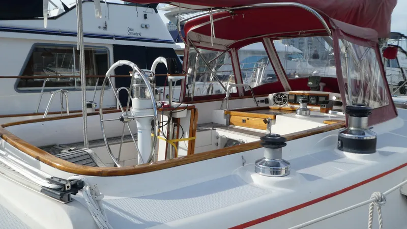 Slide: The Image of 1990 Celestial 48 Center Cockpit sailboat with red canopy and dual steering wheels. - 6