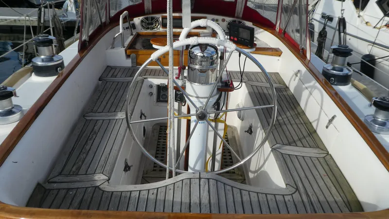 Slide: The Image of 1990 Celestial 48 Center Cockpit with wooden deck and steering wheel. - 7