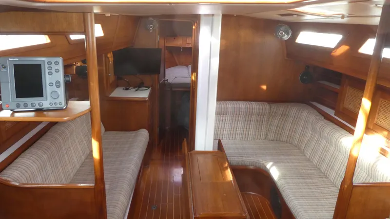 Slide: The Image of Interior of 1990 Celestial 48 Center Cockpit sailboat with wood finish and seating area. - 8