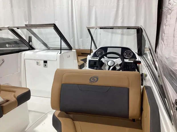 Slide: The Image of 2024 Hurricane SD235-OB boat interior with steering wheel and seating. - 12