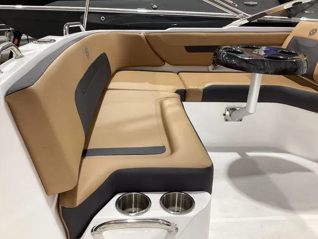 Slide: The Image of 2024 Hurricane SD235-OB boat interior with tan seating and cup holders. - 13