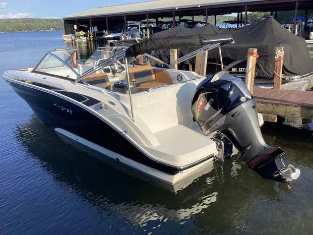 Slide: The Image of 2024 Hurricane SD235-OB boat with outboard motor in a showroom. - 2