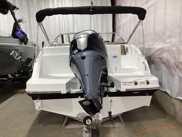 Slide: The Image of 2024 Hurricane SD235-OB boat docked at marina, sleek design, black and white exterior. - 3