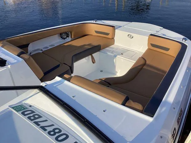 Slide: The Image of 2024 Hurricane SD235-OB boat interior with tan seating, on calm water. - 6
