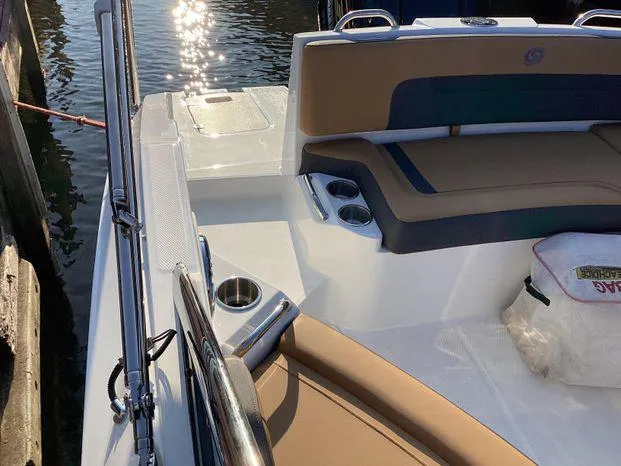 Slide: The Image of 2024 Hurricane SD235-OB boat interior with cushioned seating and cup holders. - 9