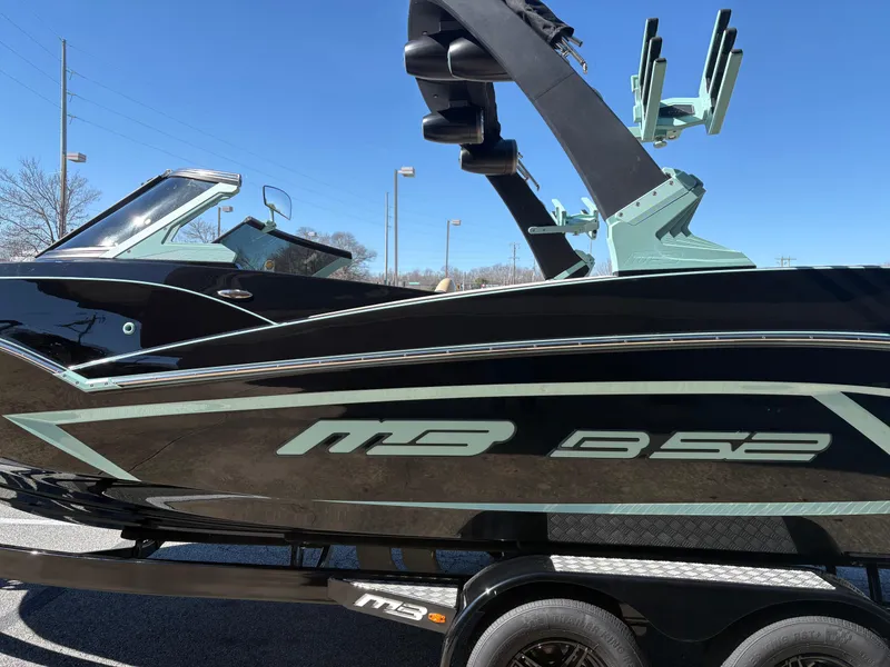 Slide: The Image of 2022 MB B52 Alpha boat with sleek black design and modern features. - 1