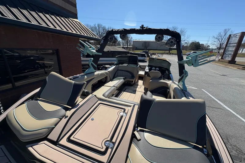 Slide: The Image of 2022 MB B52 Alpha boat with spacious seating and modern design in a parking lot. - 11