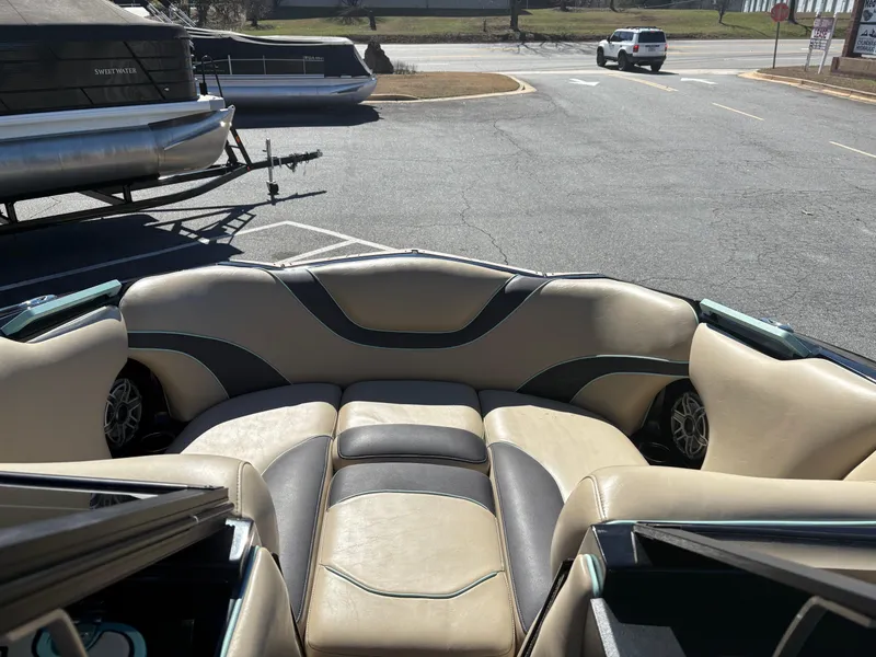 Slide: The Image of 2022 MB B52 Alpha boat interior with beige seating in a parking lot. - 8