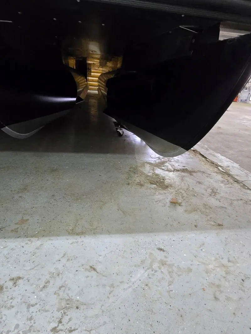 Slide: The Image of Underneath view of 2025 SunChaser Eclipse 23 SBX DH boat in a garage. - 6