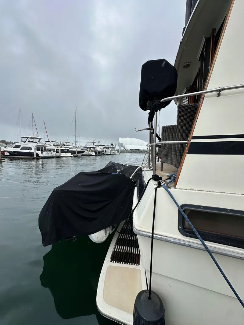 Slide: The Image of 1985 Gulfstar 49 Motor Yacht docked in a marina on a cloudy day. - 13
