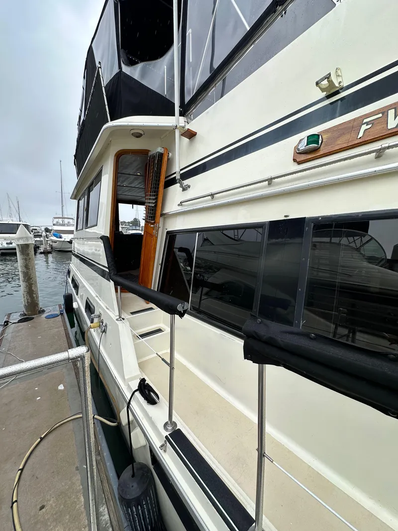 Slide: The Image of 1985 Gulfstar 49 Motor Yacht docked at marina, side view. - 15