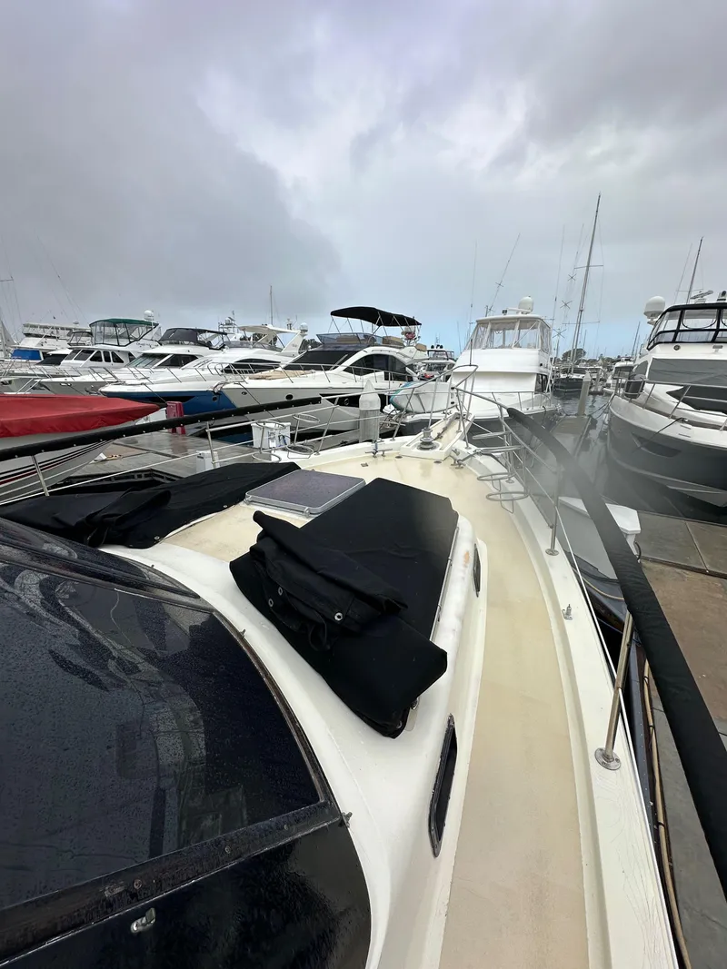 Slide: The Image of 1985 Gulfstar 49 Motor Yacht docked among other boats on a cloudy day. - 17