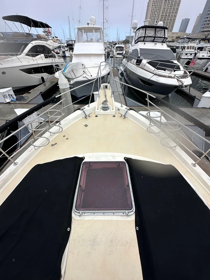Slide: The Image of 1985 Gulfstar 49 Motor Yacht docked among other boats in a marina. - 18