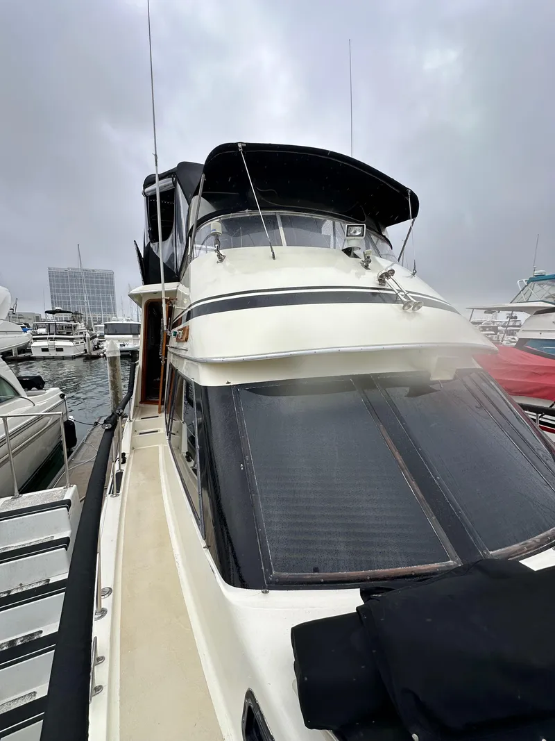 Slide: The Image of 1985 Gulfstar 49 Motor Yacht docked at marina, overcast sky. - 22
