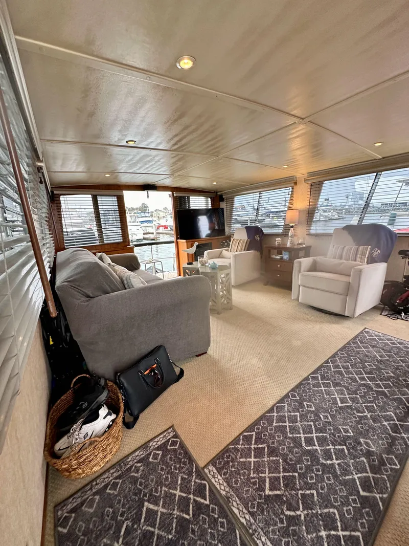 Slide: The Image of Interior of 1985 Gulfstar 49 Motor Yacht with cozy seating and large windows. - 24