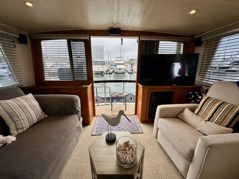 Slide: The Image of Interior of 1985 Gulfstar 49 Motor Yacht with cozy seating and marina view. - 27