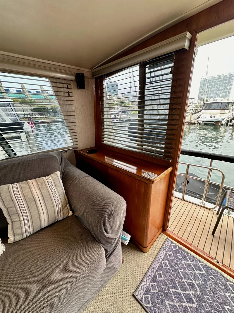 Slide: The Image of Interior of 1985 Gulfstar 49 Motor Yacht with waterfront view and cozy seating area. - 29