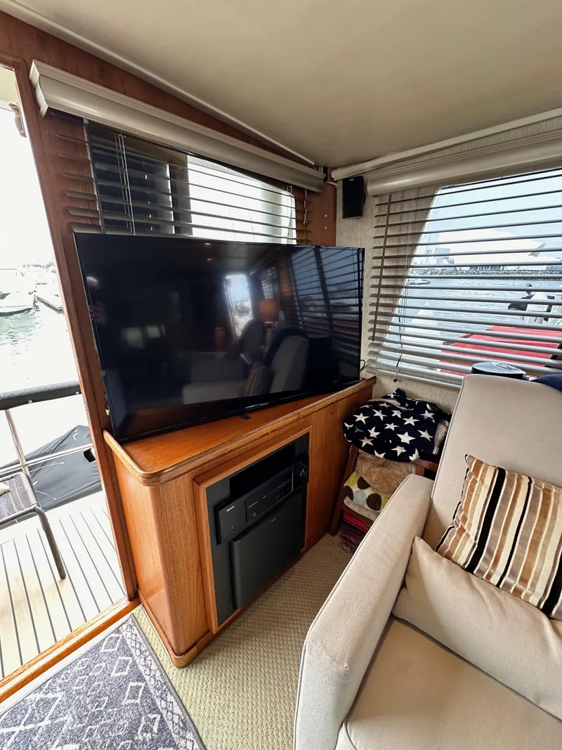 Slide: The Image of Interior of 1985 Gulfstar 49 Motor Yacht with TV, seating, and window view. - 30