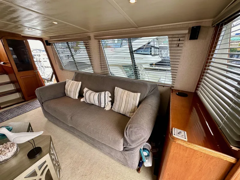 Slide: The Image of Interior of 1985 Gulfstar 49 Motor Yacht with cozy sofa and decorative pillows. - 36