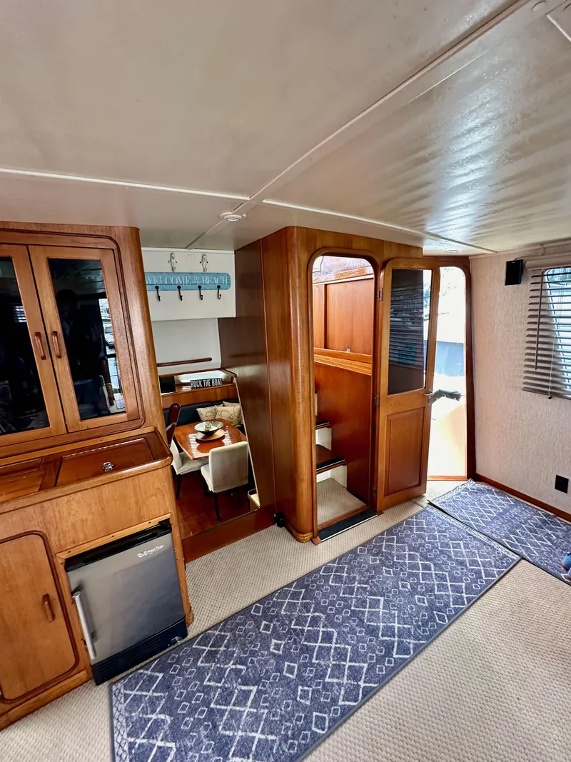Slide: The Image of Interior of 1985 Gulfstar 49 Motor Yacht with wooden cabinetry and carpeted flooring. - 38