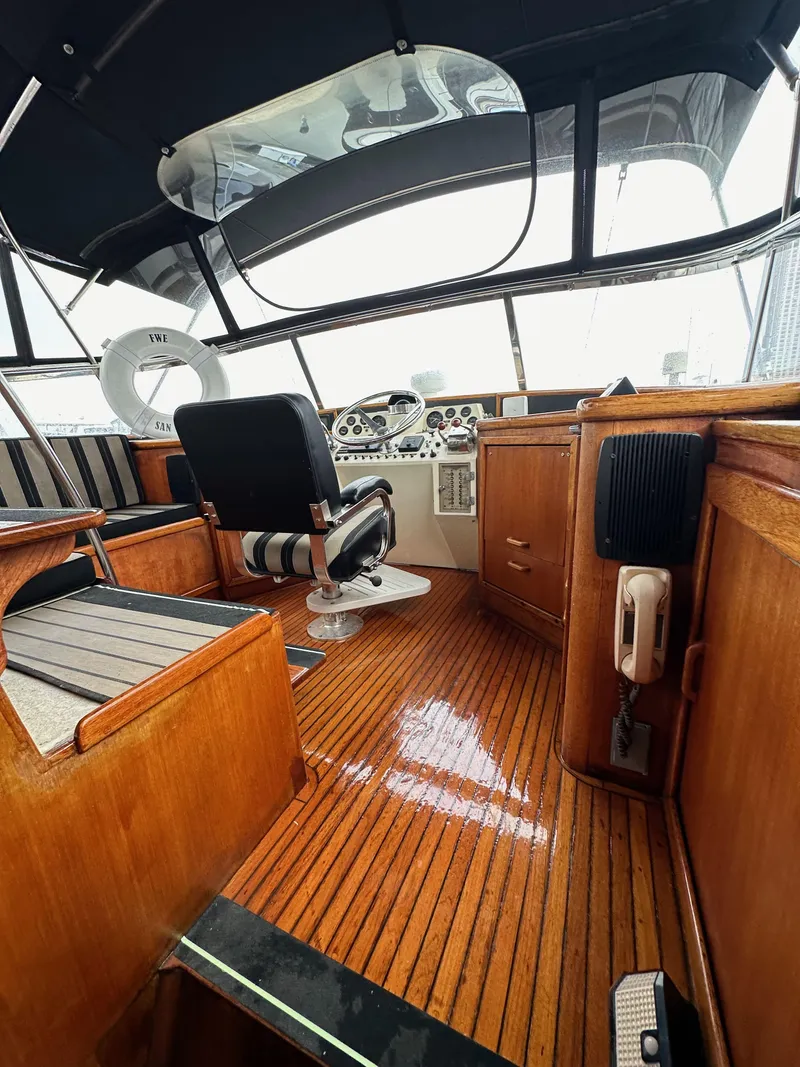 Slide: The Image of 1985 Gulfstar 49 Motor Yacht interior with polished wood and modern helm. - 40