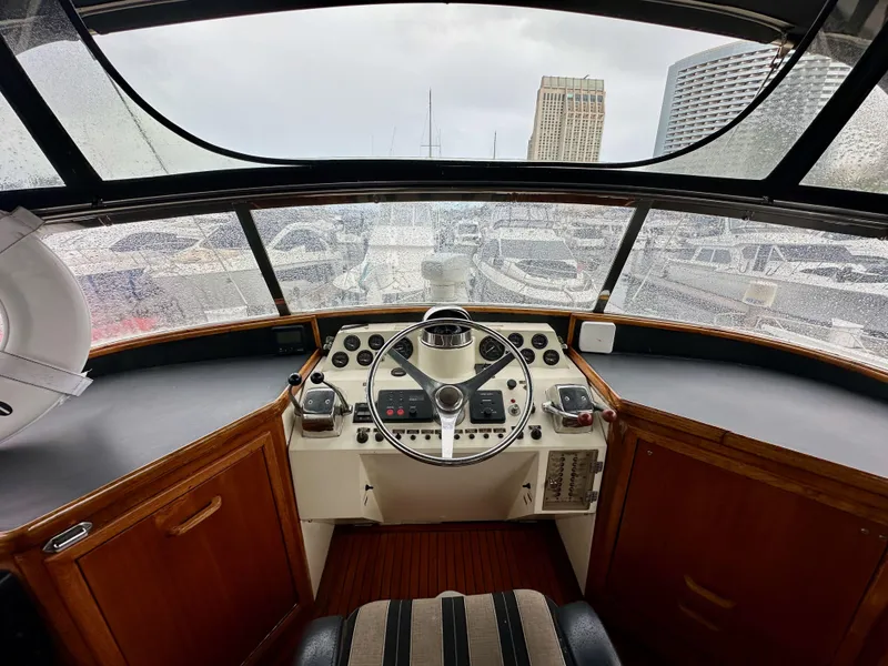 Slide: The Image of 1985 Gulfstar 49 Motor Yacht helm with steering wheel and control panel. - 42